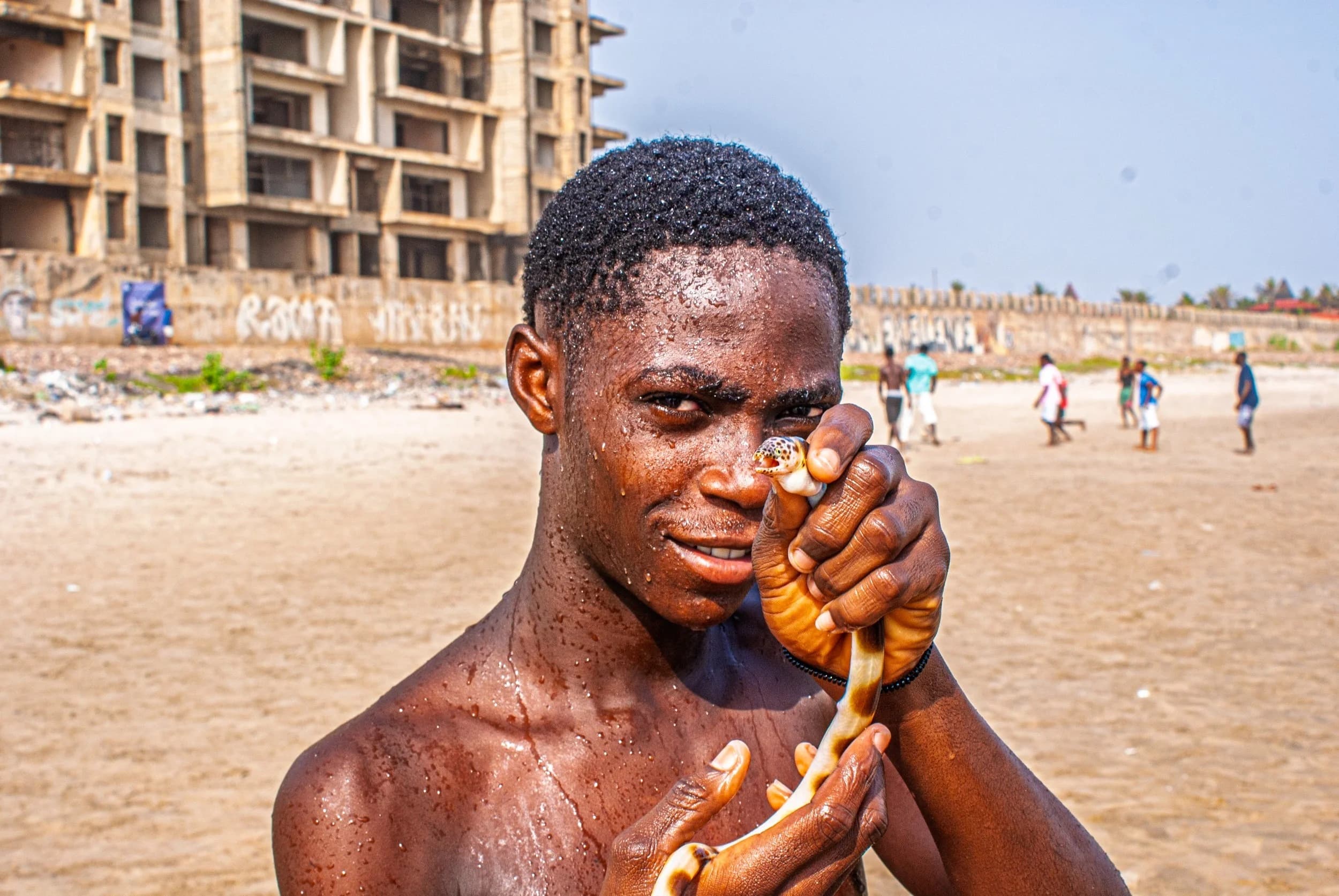 Image of a boy holding an aquatic snake