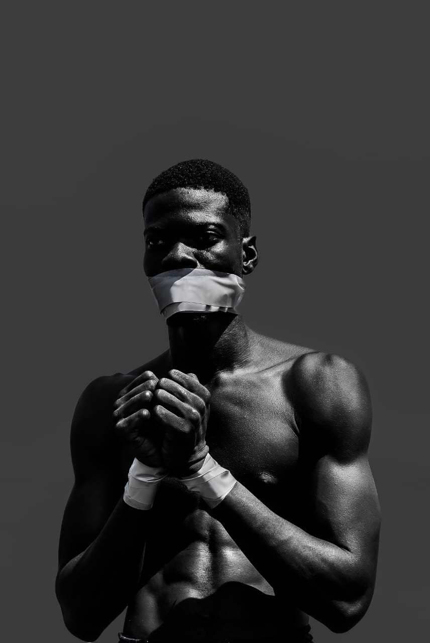 Man with tape on his mouth and his hands tied
