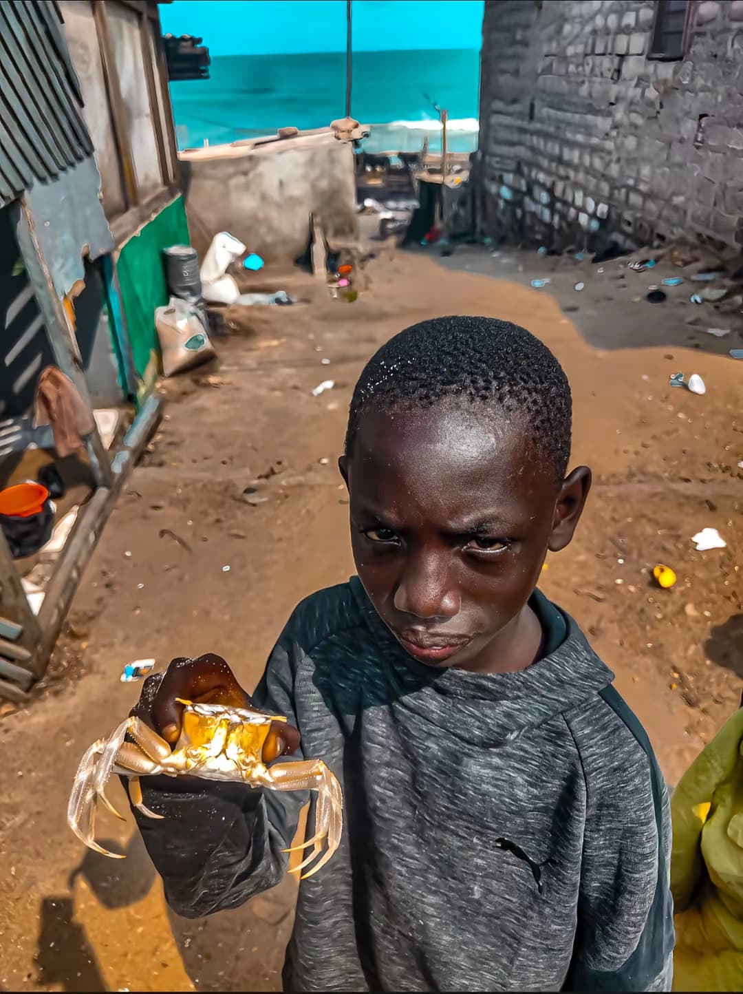 A boy holding a crab